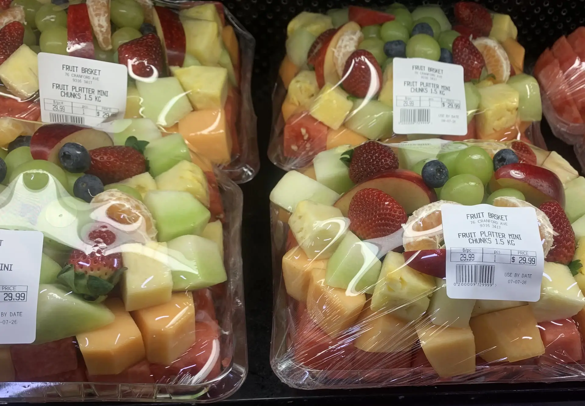 Mini sliced fruit platter trays packed fresh in the cold case
