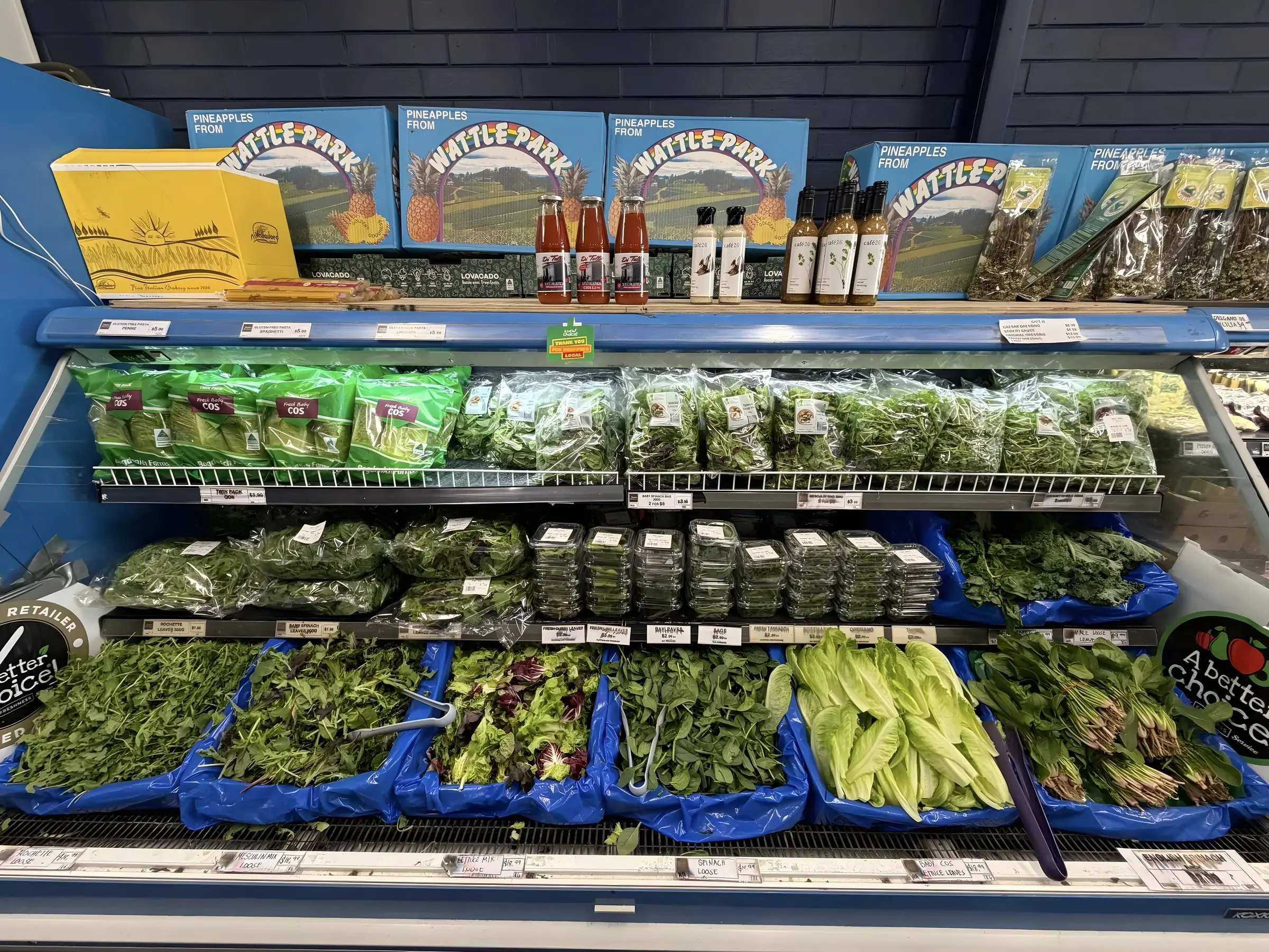 Refrigerated case with fresh leafy greens, herbs and lettuce packages