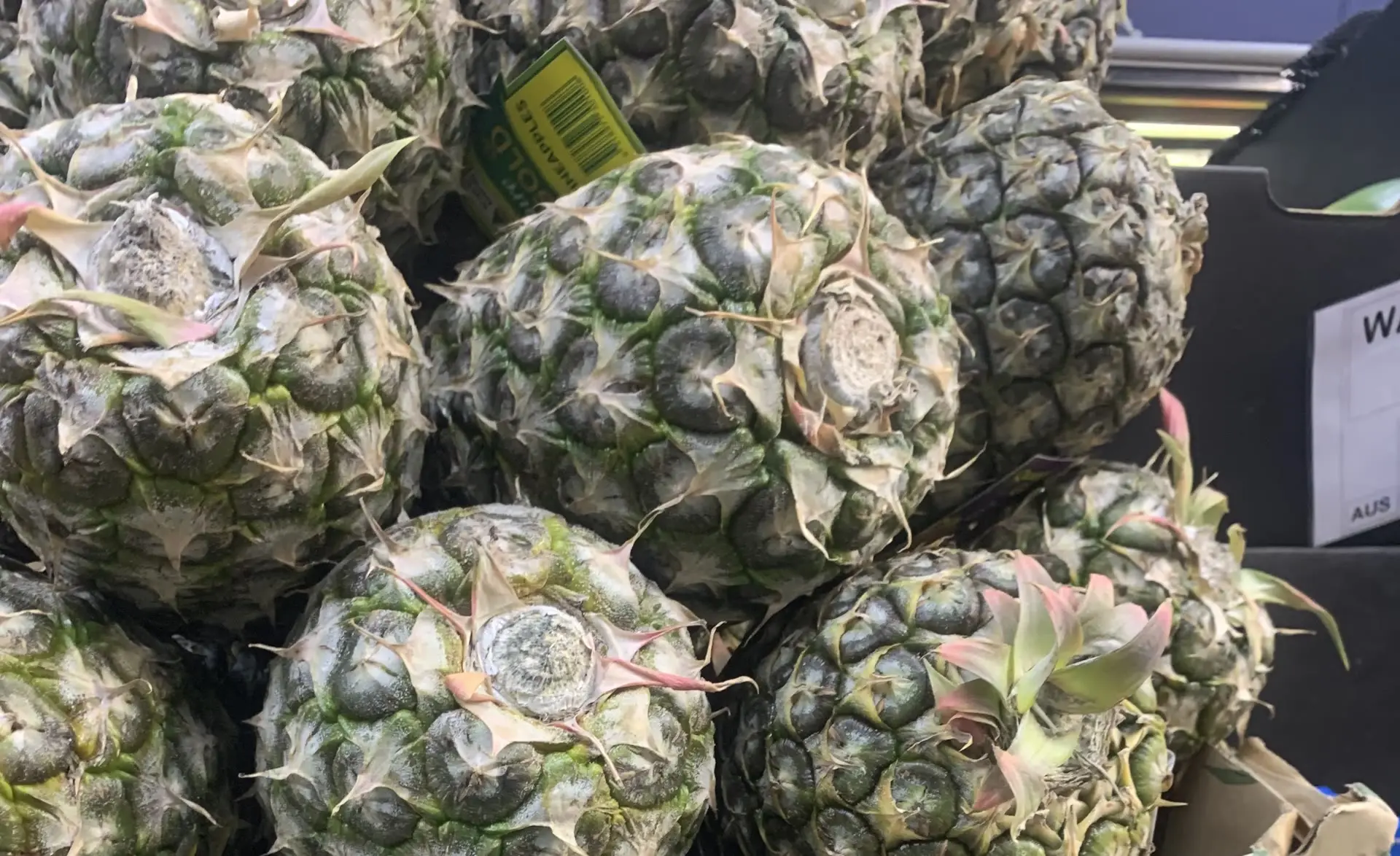 Large whole pineapples stacked in the crate