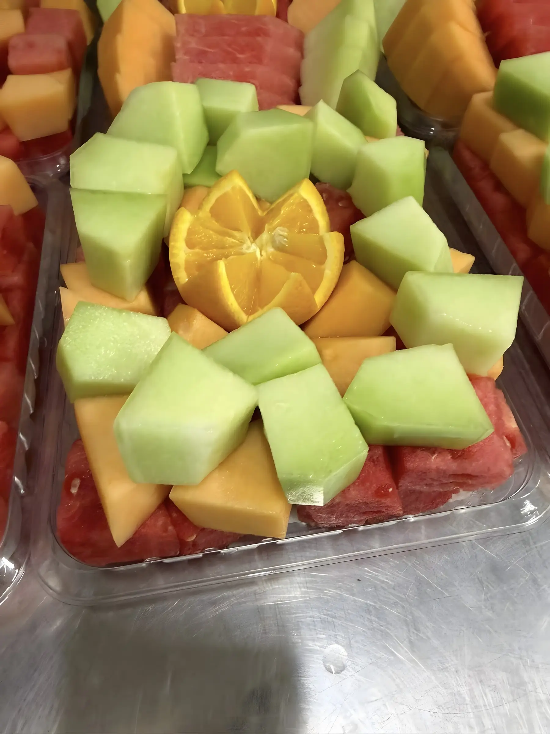 Cantaloupe and watermelon cut fruit platter ready for collection